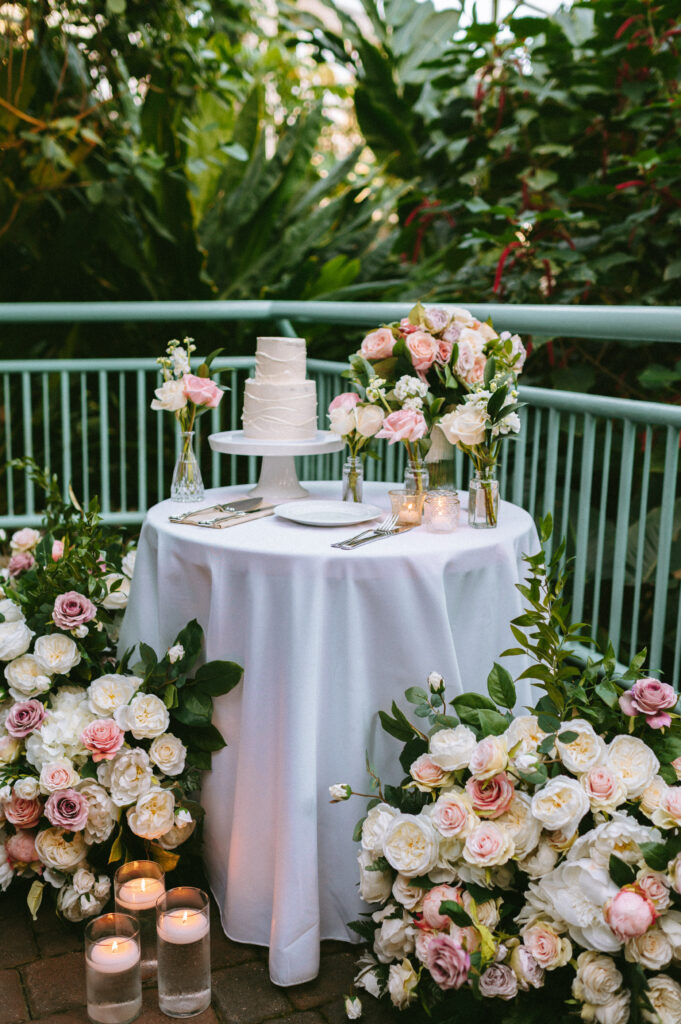 Wedding cake table surrounded by florals