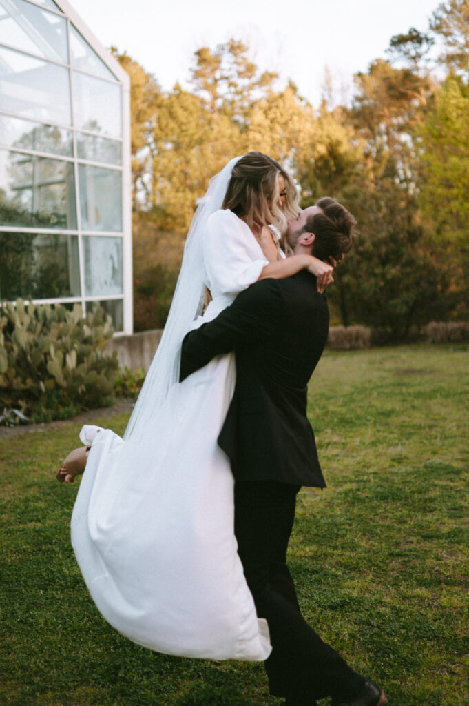 Romantic image of groom holding and spinning bride around in a circle