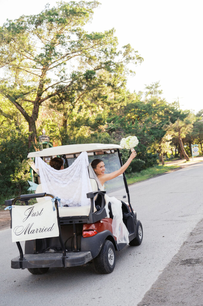 bride and groom in a golf cart