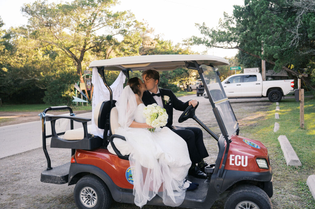 bride and groom in a golf cart