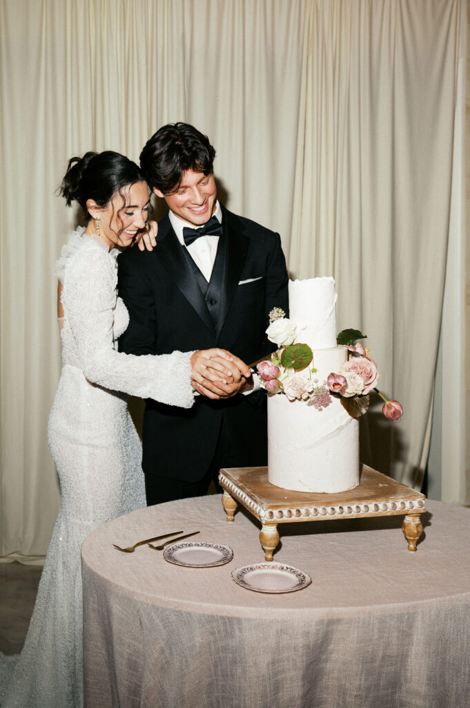 bride and groom cutting their wedding cake