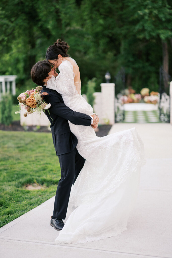 joyful bride and groom at the greenhouse at arrows farm, a nc greenhouse wedding venue