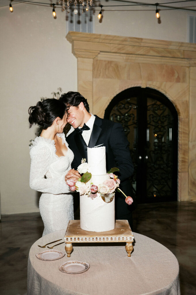bride and groom cutting their wedding cake