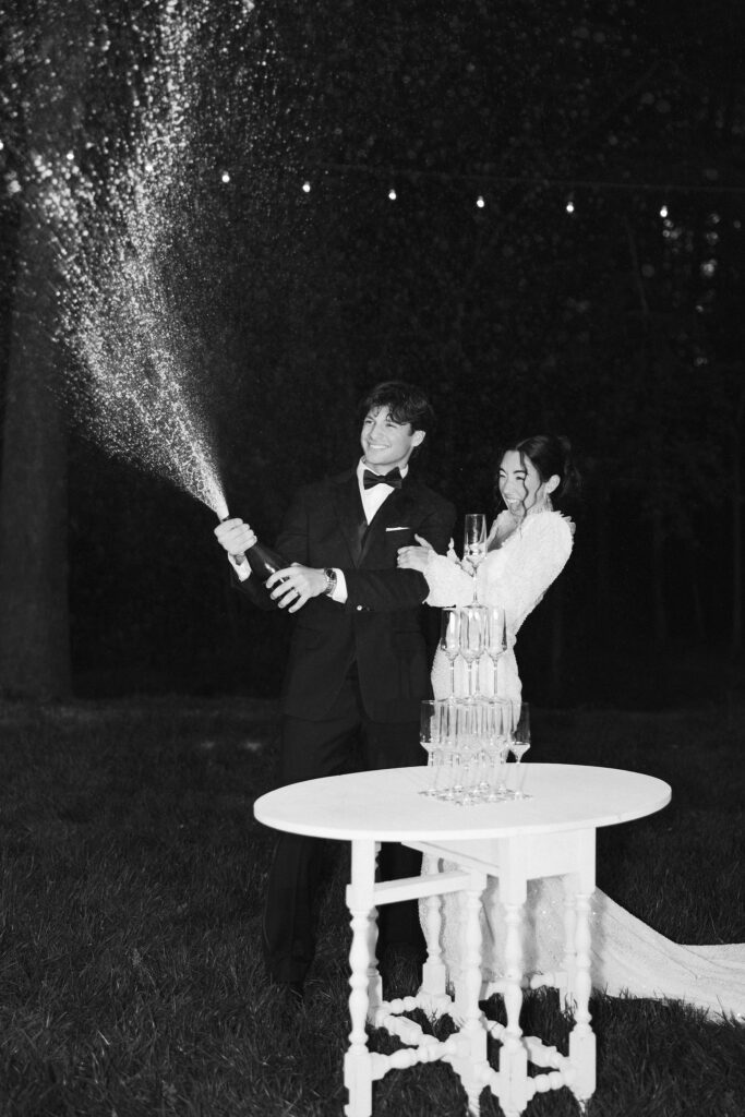 fun and playful moments of bride and groom popping champagne