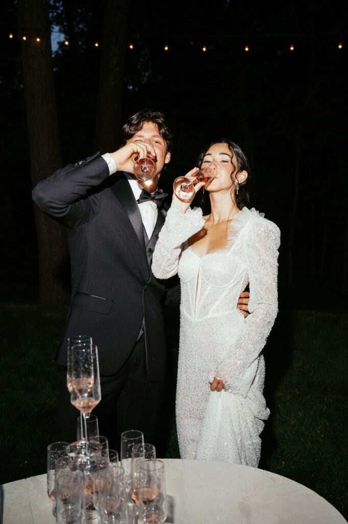 fun and playful moments of bride and groom enjoying champagne